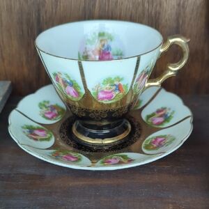 Vintage Saji Japan teacup and saucer set with a black base